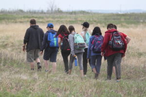 Students walk through the Meewasin Northeast Swale